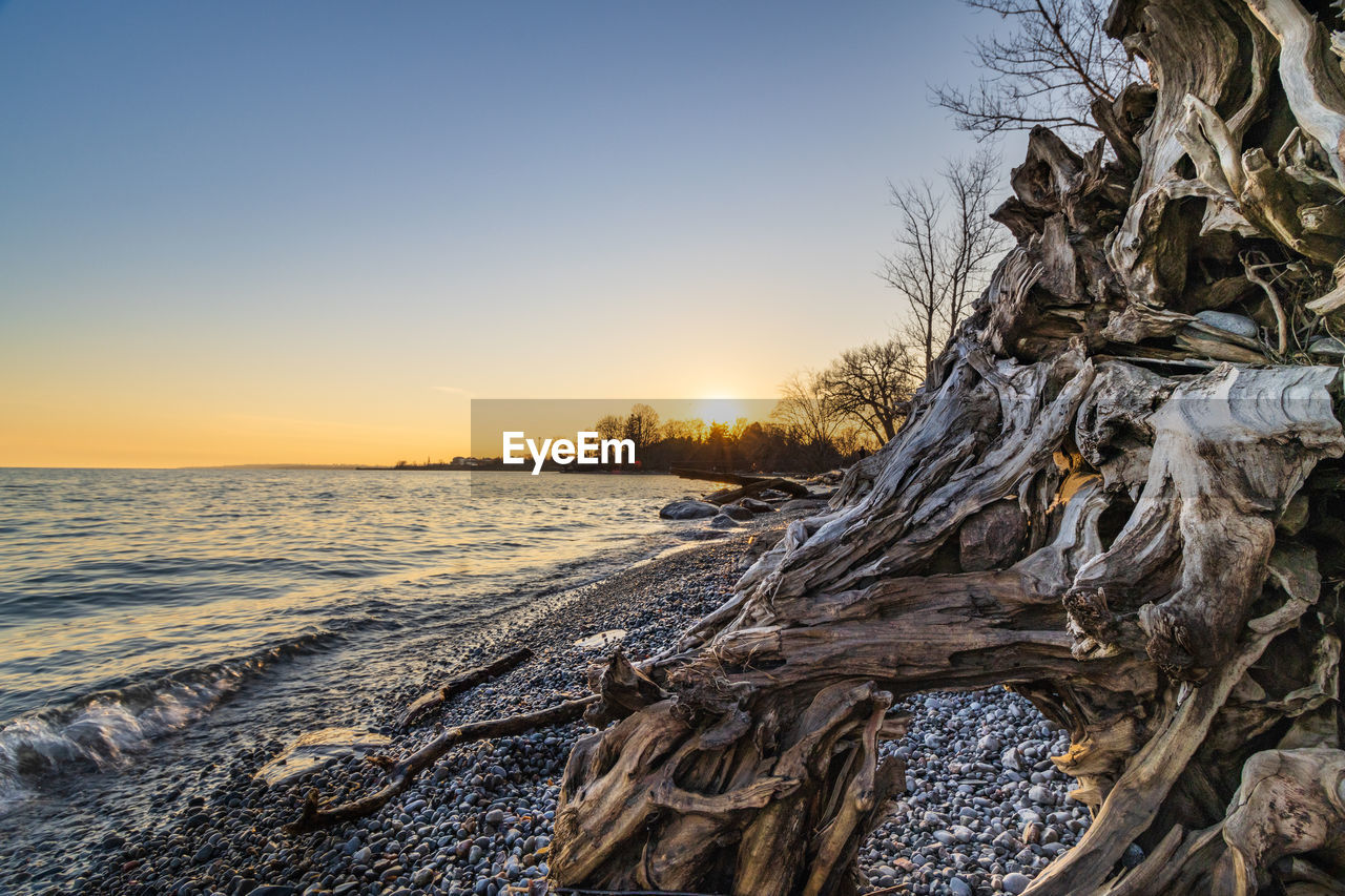 Scenic view of frozen sea against sky during sunset