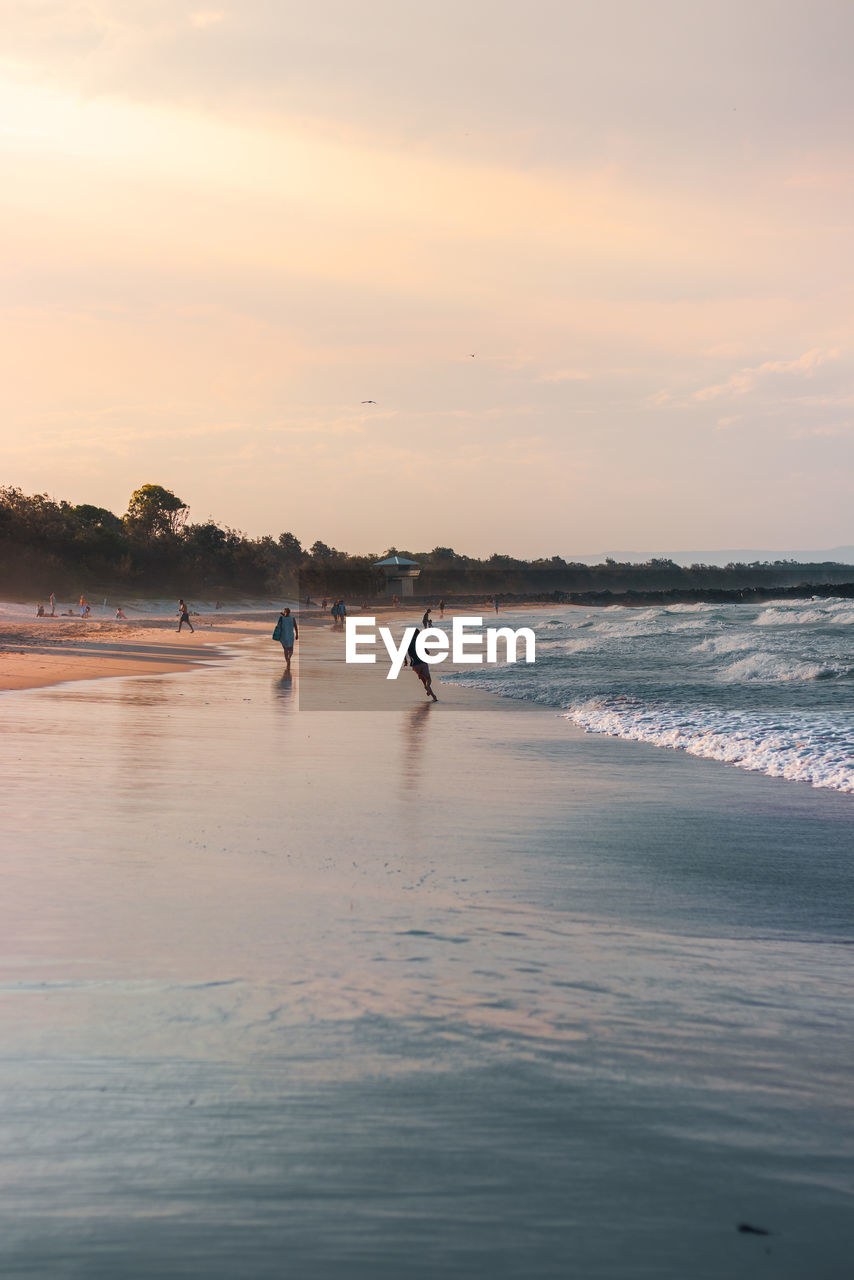 SCENIC VIEW OF BEACH AGAINST SKY DURING SUNSET