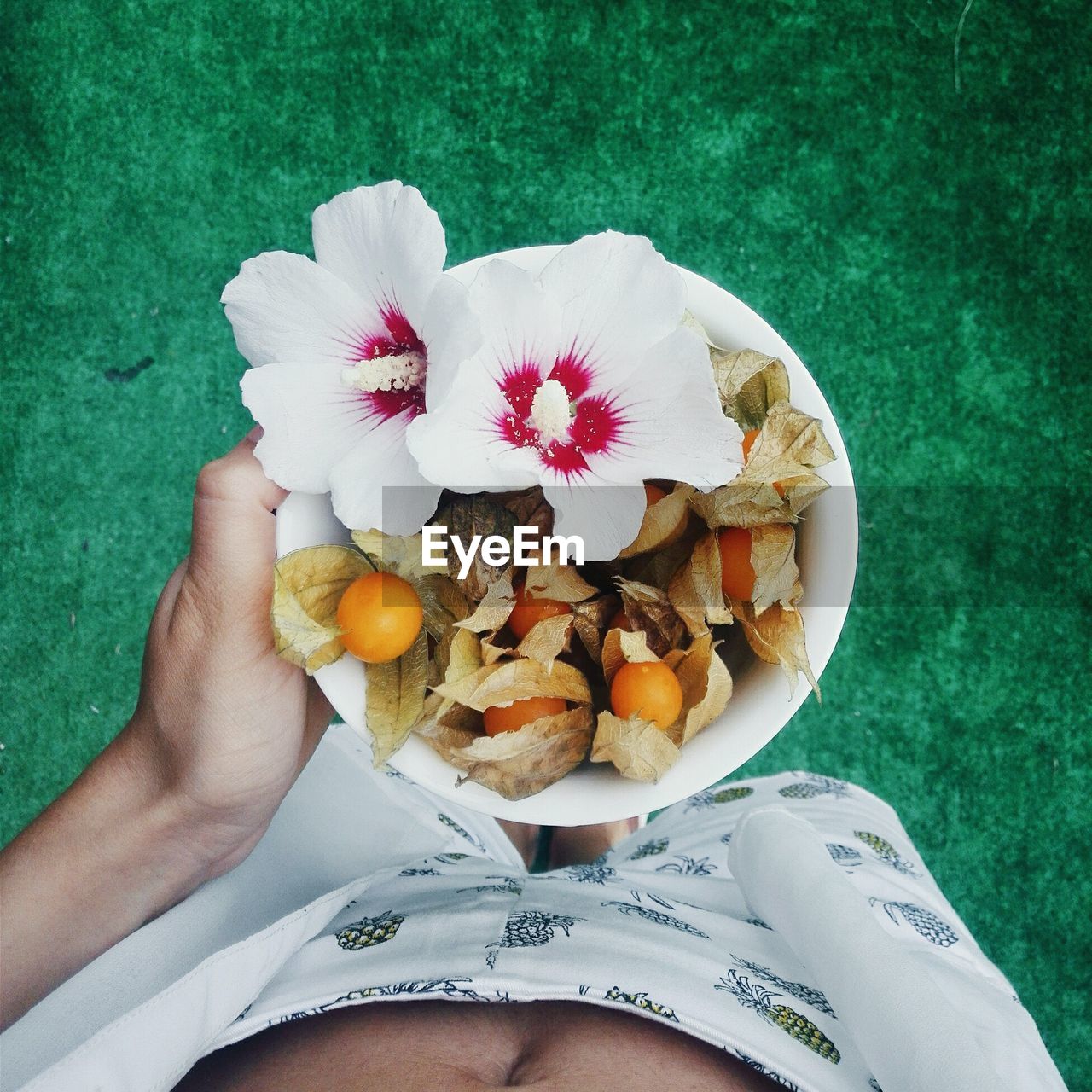 Midsection of man holding fruits in bowl