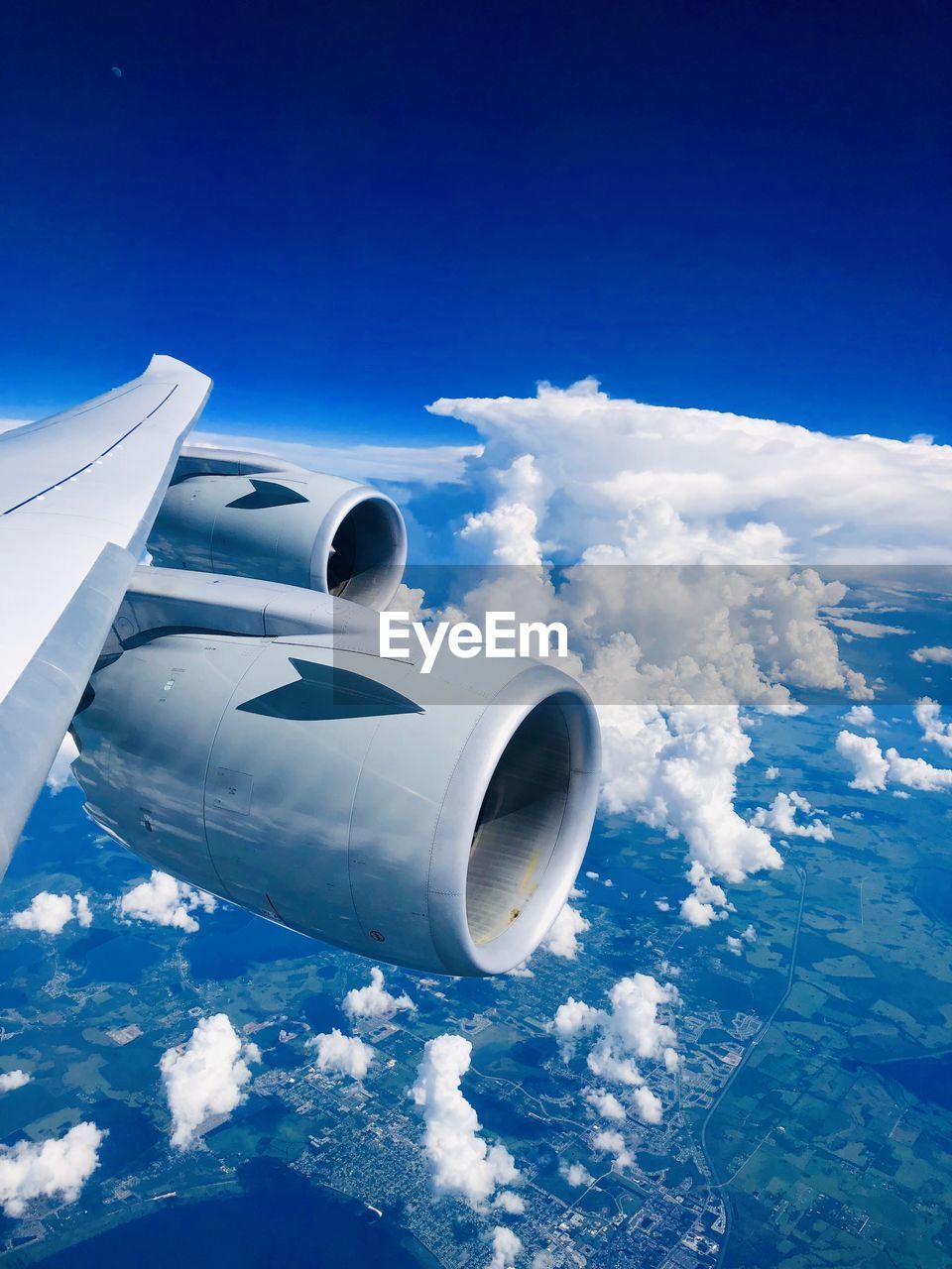 View of airplane wing against clouds