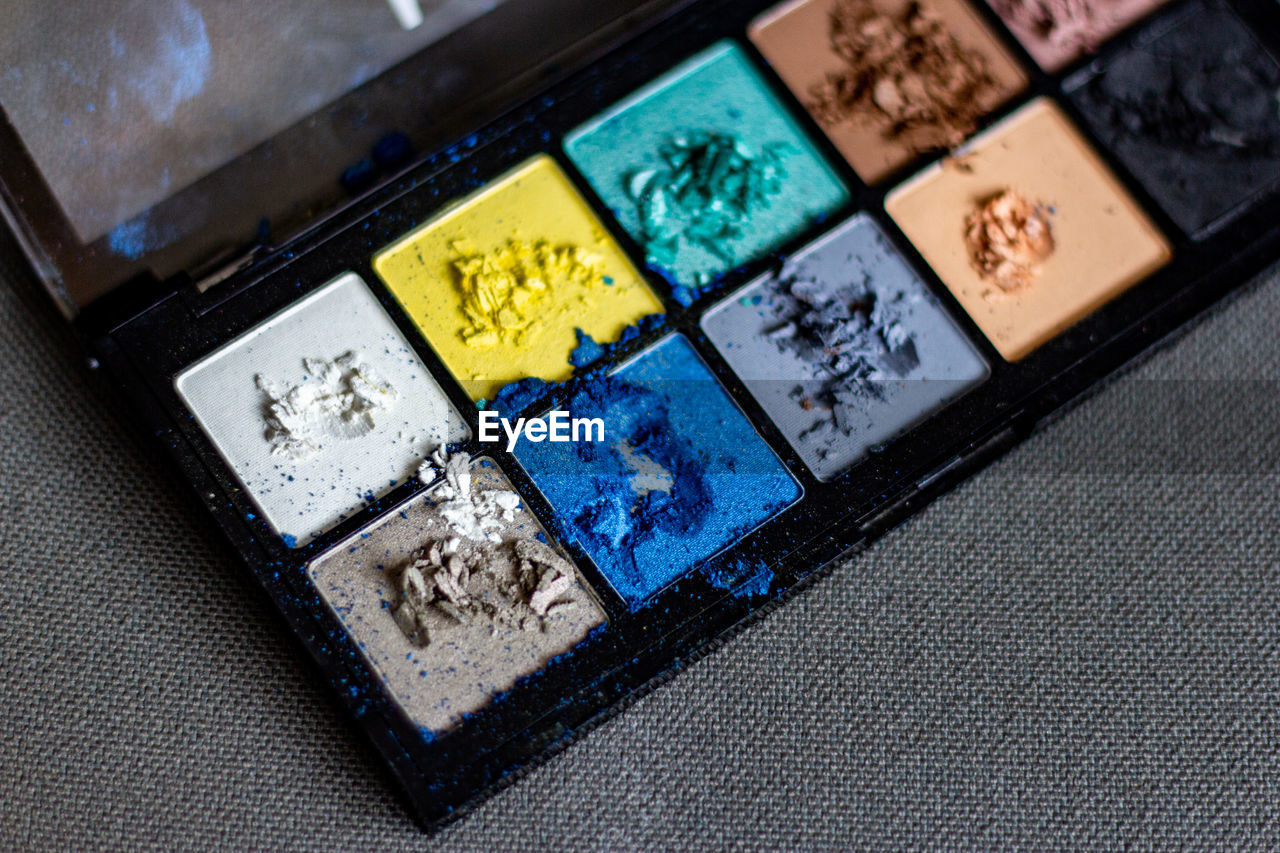High angle view of cracked  cosmetic palette 