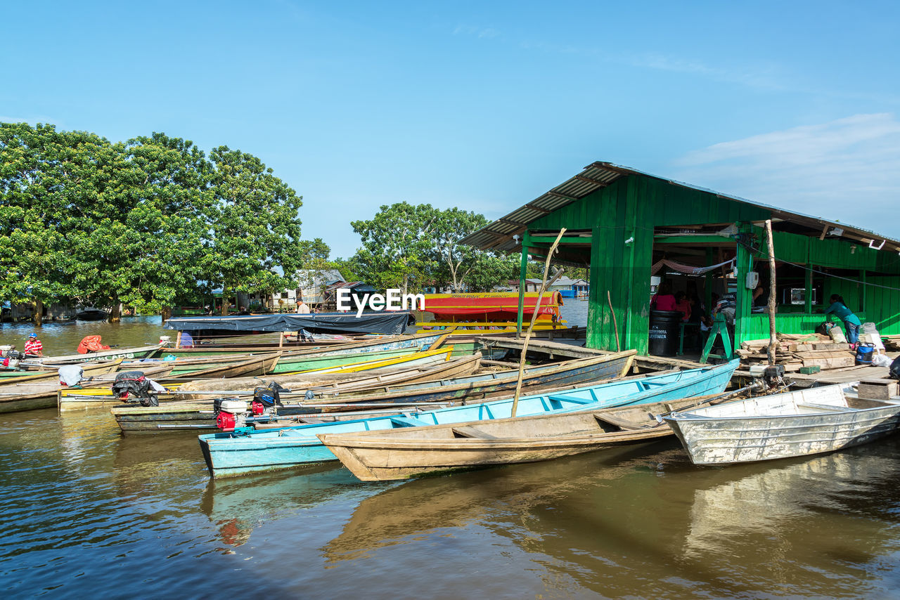 Boats moored at harbor in amazon river