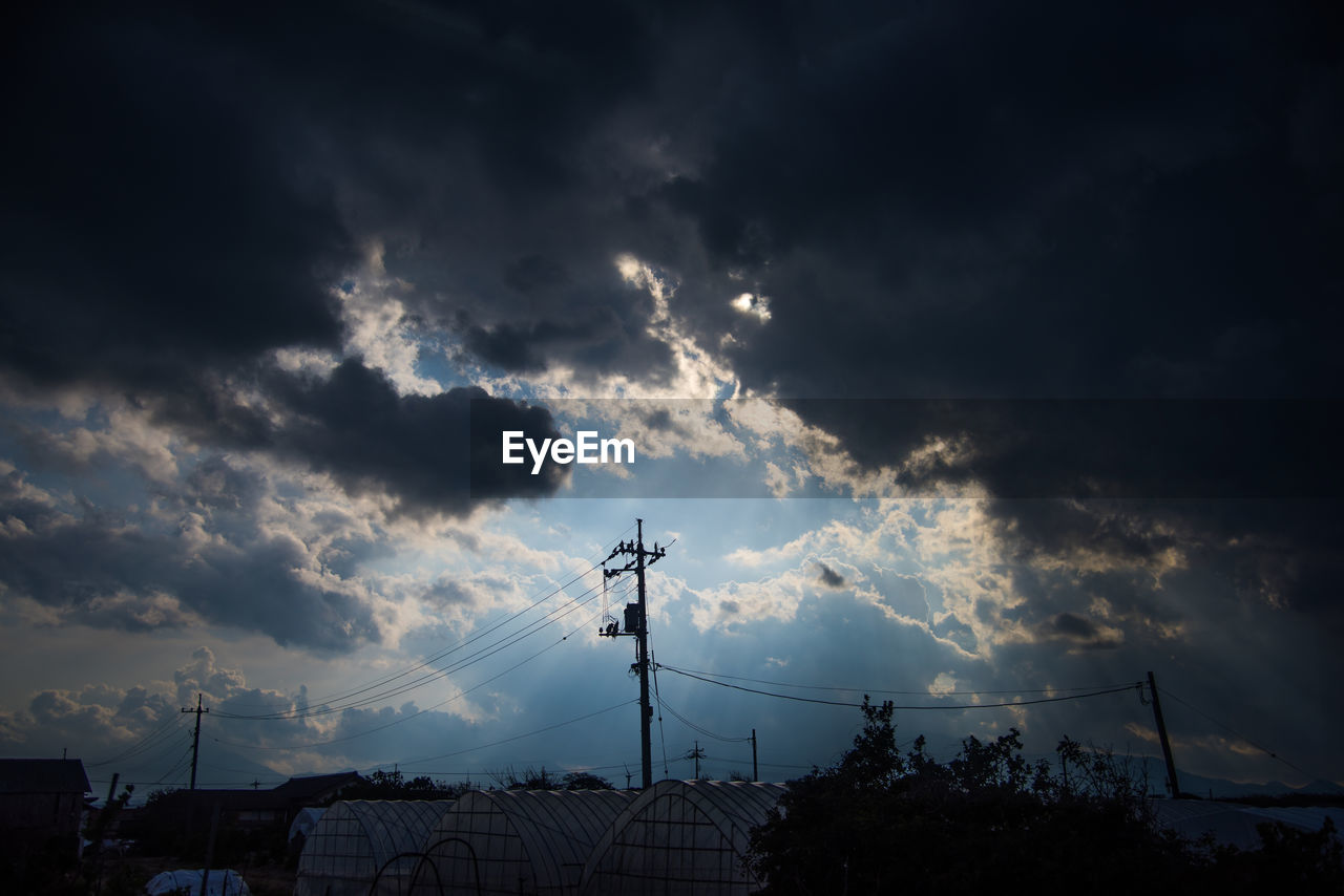 LOW ANGLE VIEW OF SILHOUETTE ELECTRICITY PYLON AGAINST SKY