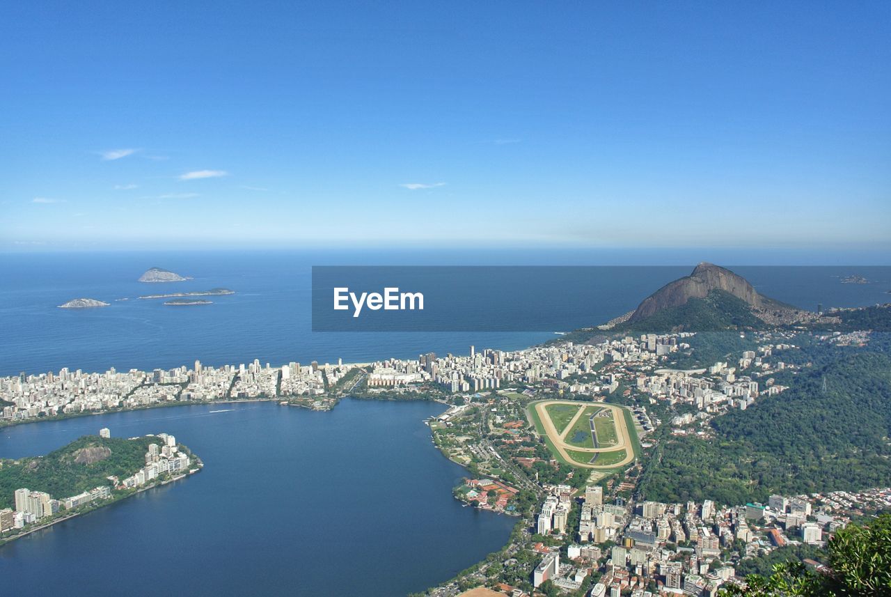 High angle view of sea and city against sky