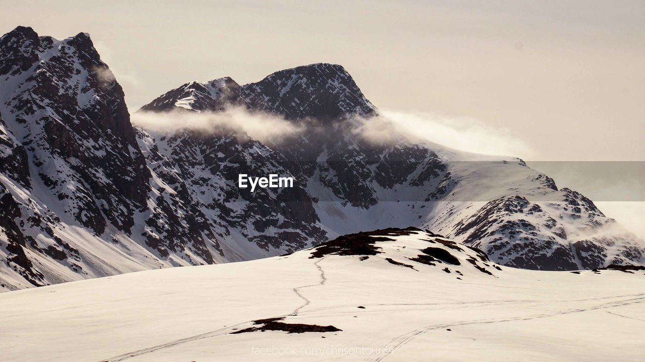 Scenic view of snowcapped mountains against sky