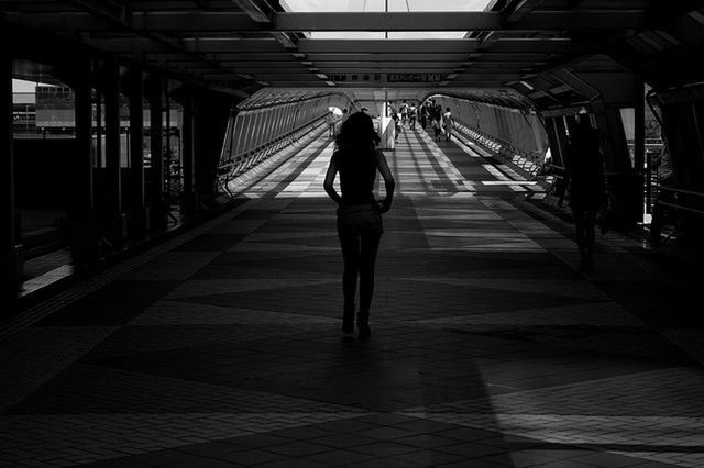 WOMAN WALKING IN CORRIDOR