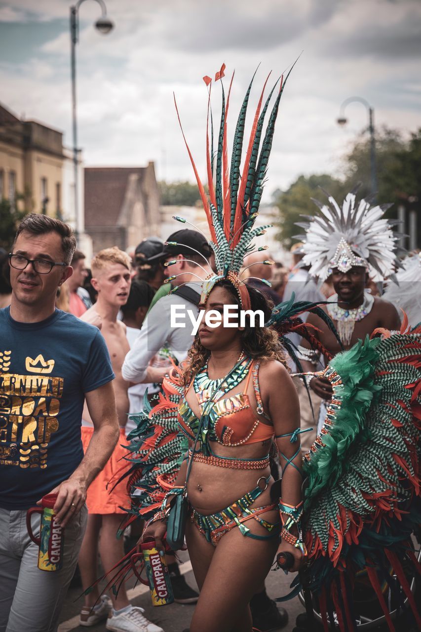 FRIENDS STANDING IN TRADITIONAL CLOTHING DURING FESTIVAL