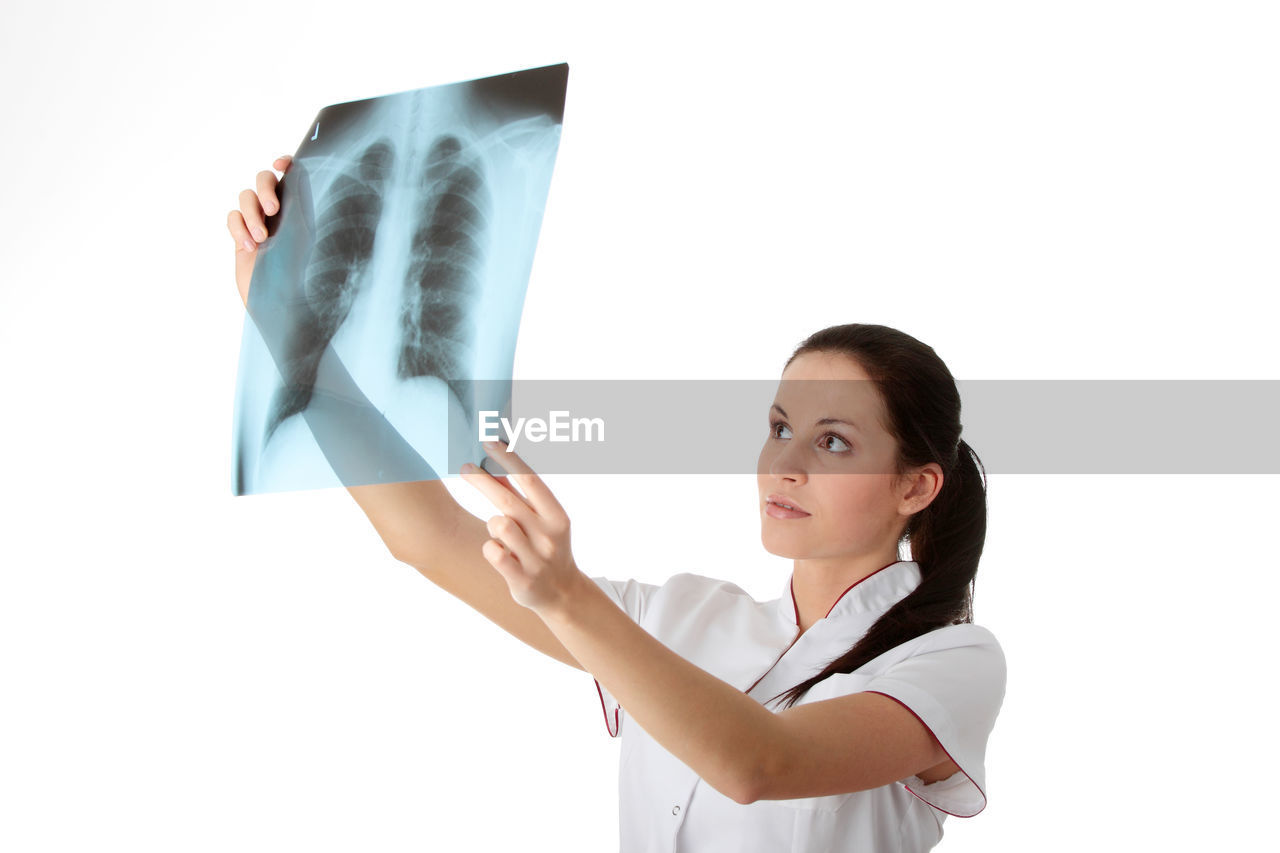 Doctor holding medical x-ray against white background