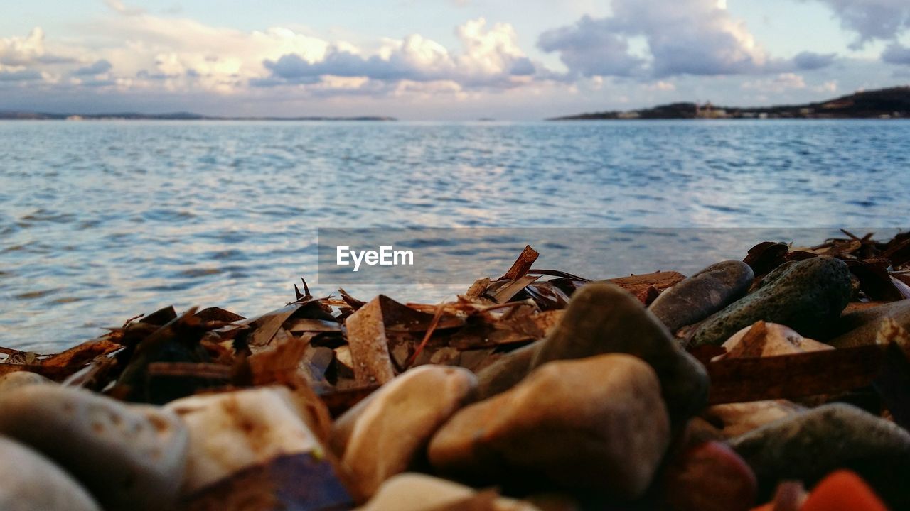 Scenic view of calm sea against cloudy sky