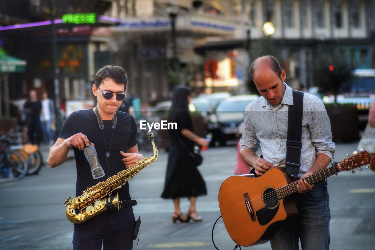 Men playing music on city street