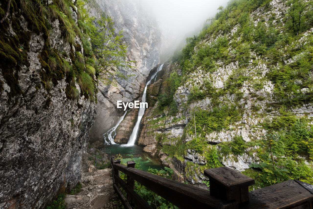 SCENIC VIEW OF WATERFALL AMIDST TREES