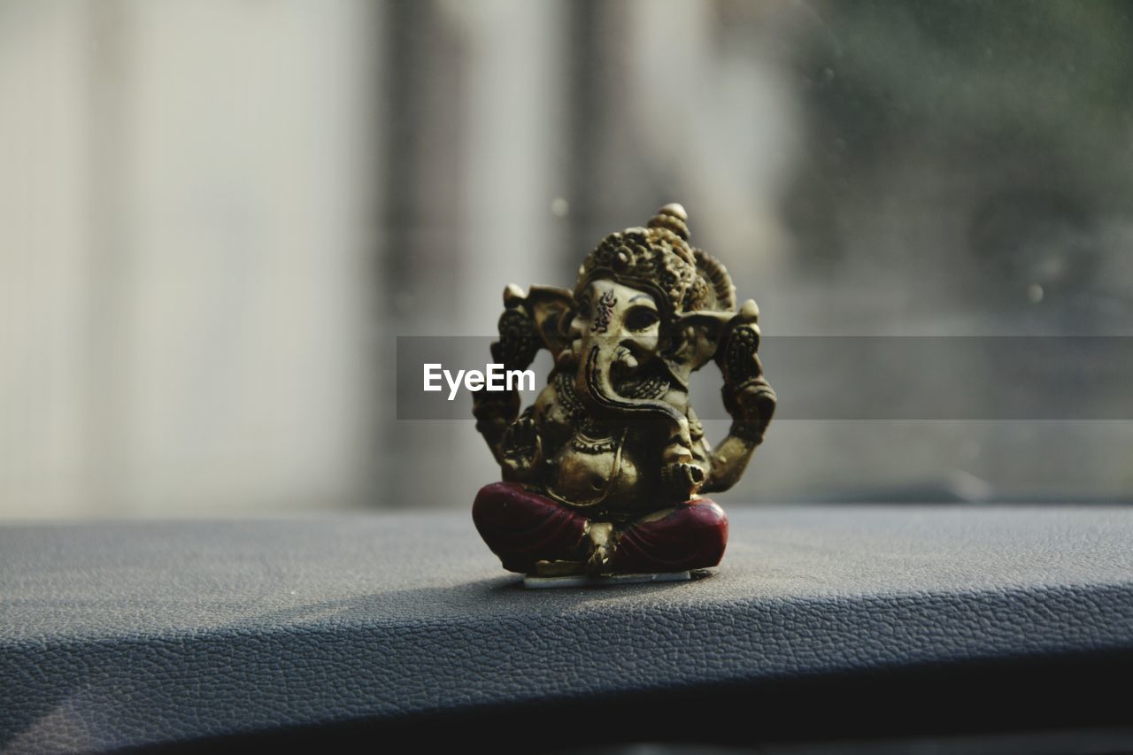 Ganesha figurine on car dashboard