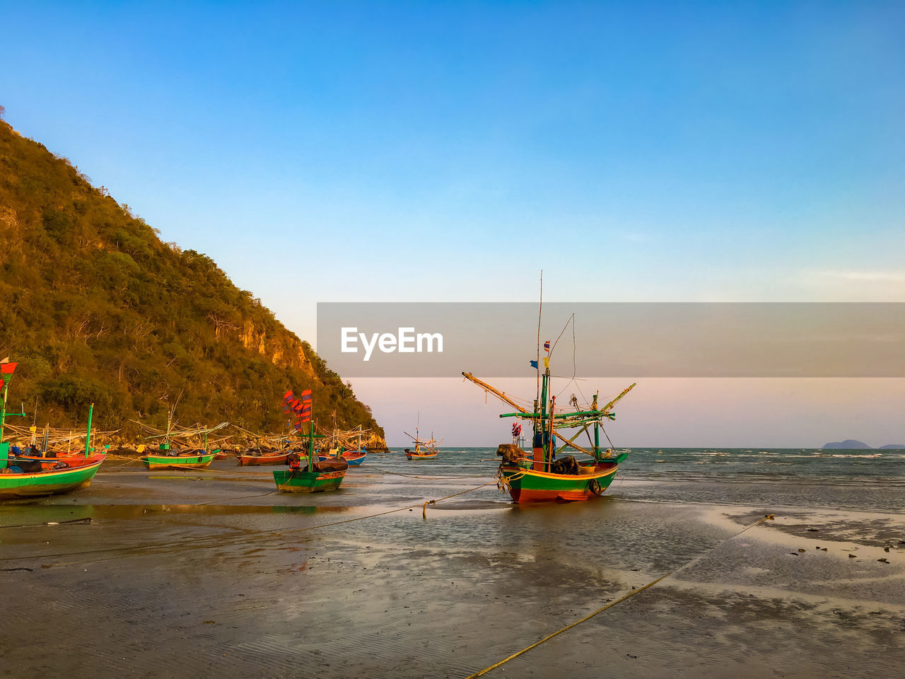 Boats moored on sea against sky