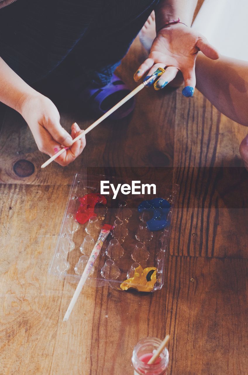 High angle view of person painting on table