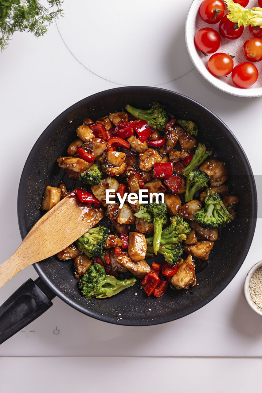 Teriyaki chicken with vegetables on a frying pan