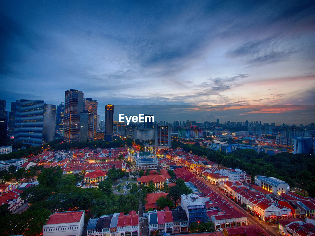 View of cityscape against cloudy sky