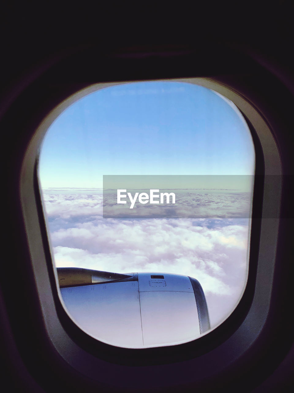 SCENIC VIEW OF CLOUDS SEEN THROUGH WINDOW