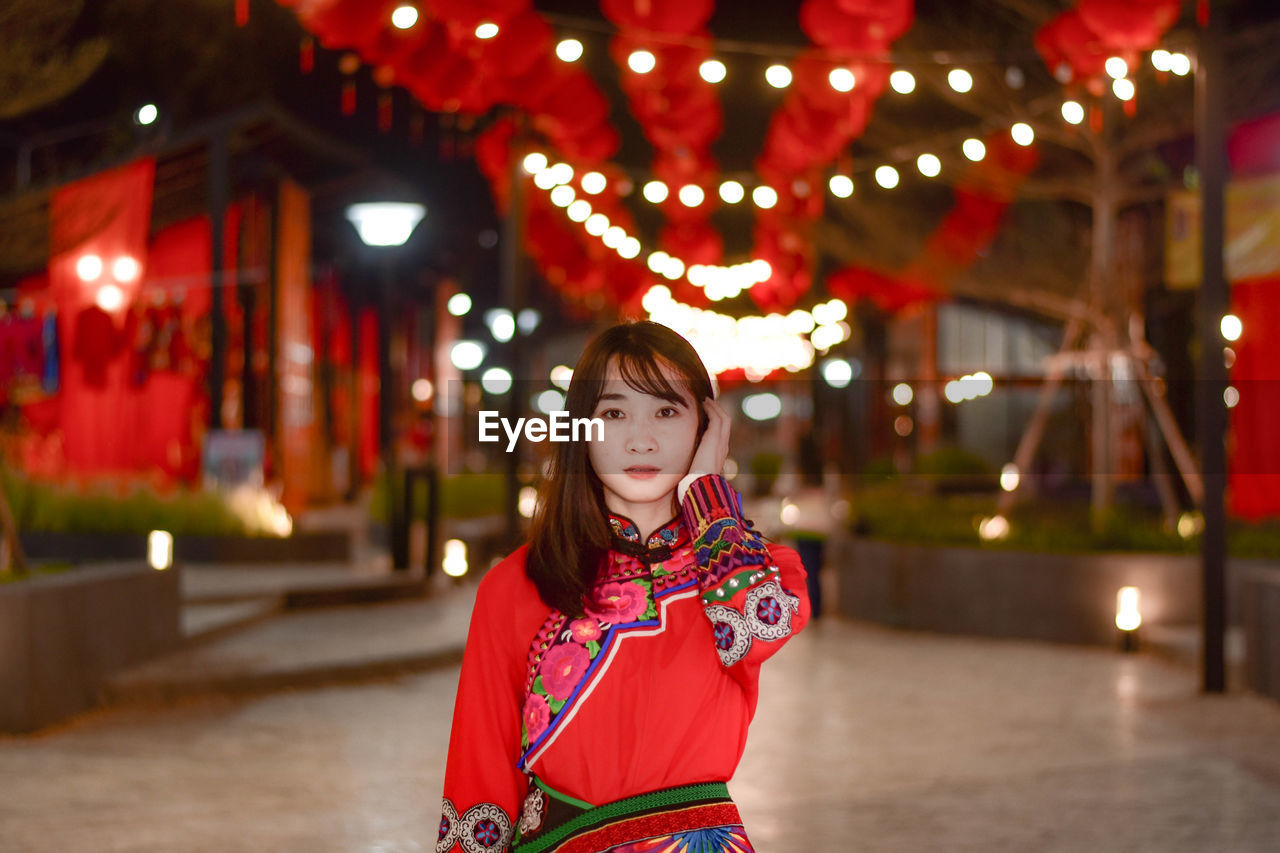 Portrait of young woman standing outdoors