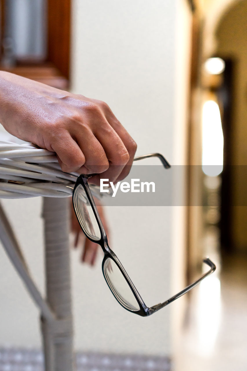 hand, adult, glasses, one person, indoors, business, close-up, eyeglasses, men, selective focus, focus on foreground, vision care, occupation, holding