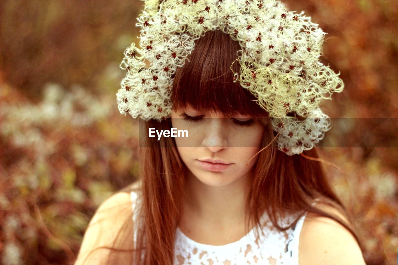 Sad young woman with flowers and bangs