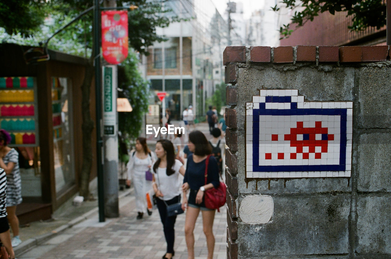 People walking on street in city