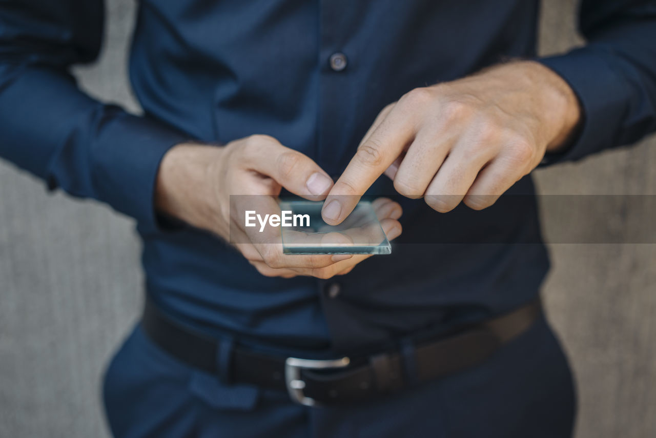 Businessman using futuristic portable device