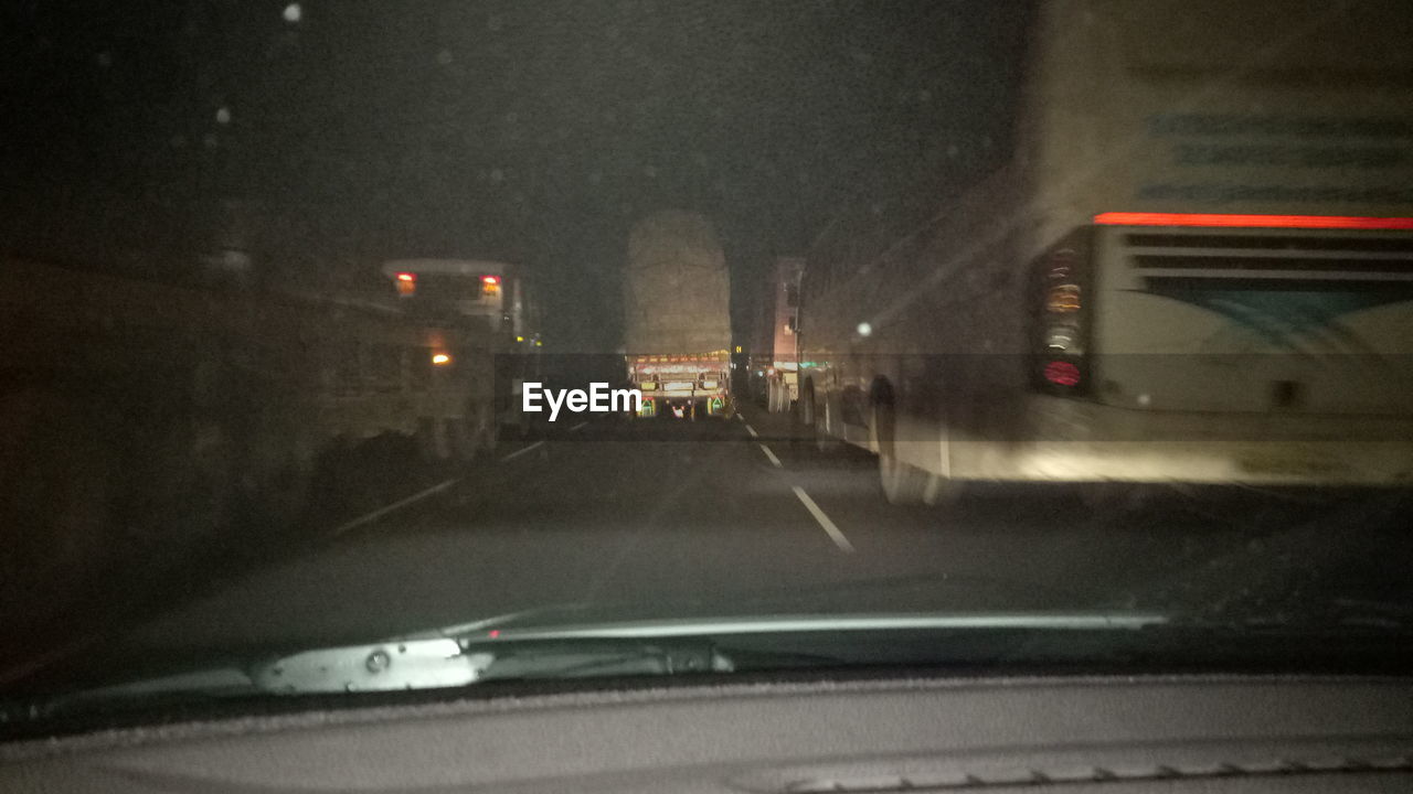 CARS ON ROAD SEEN FROM WINDSHIELD