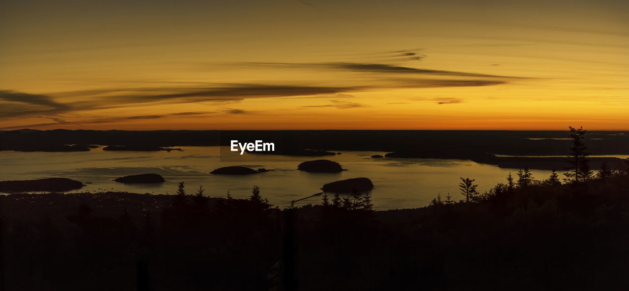 Scenic view of lake against orange sky