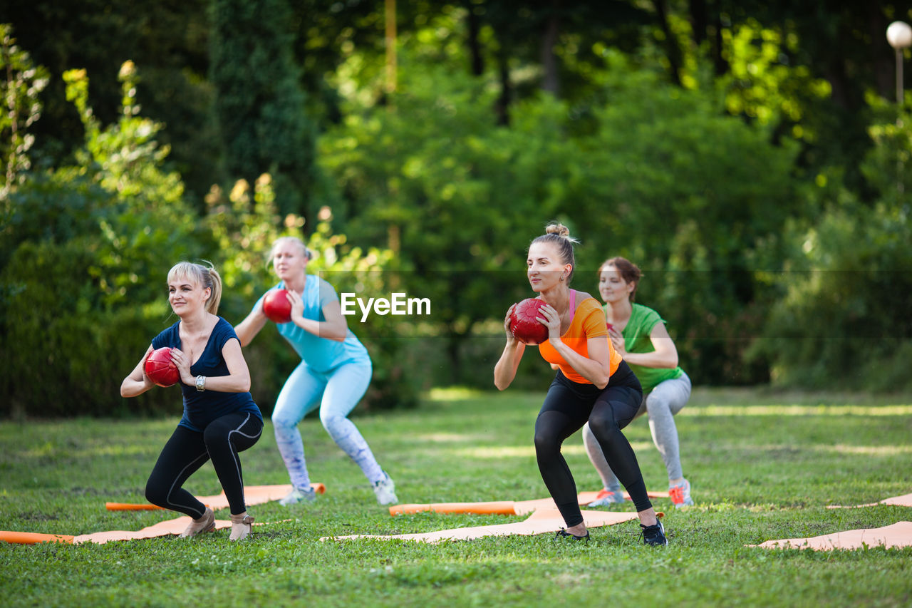 Rear view of people with girls in park