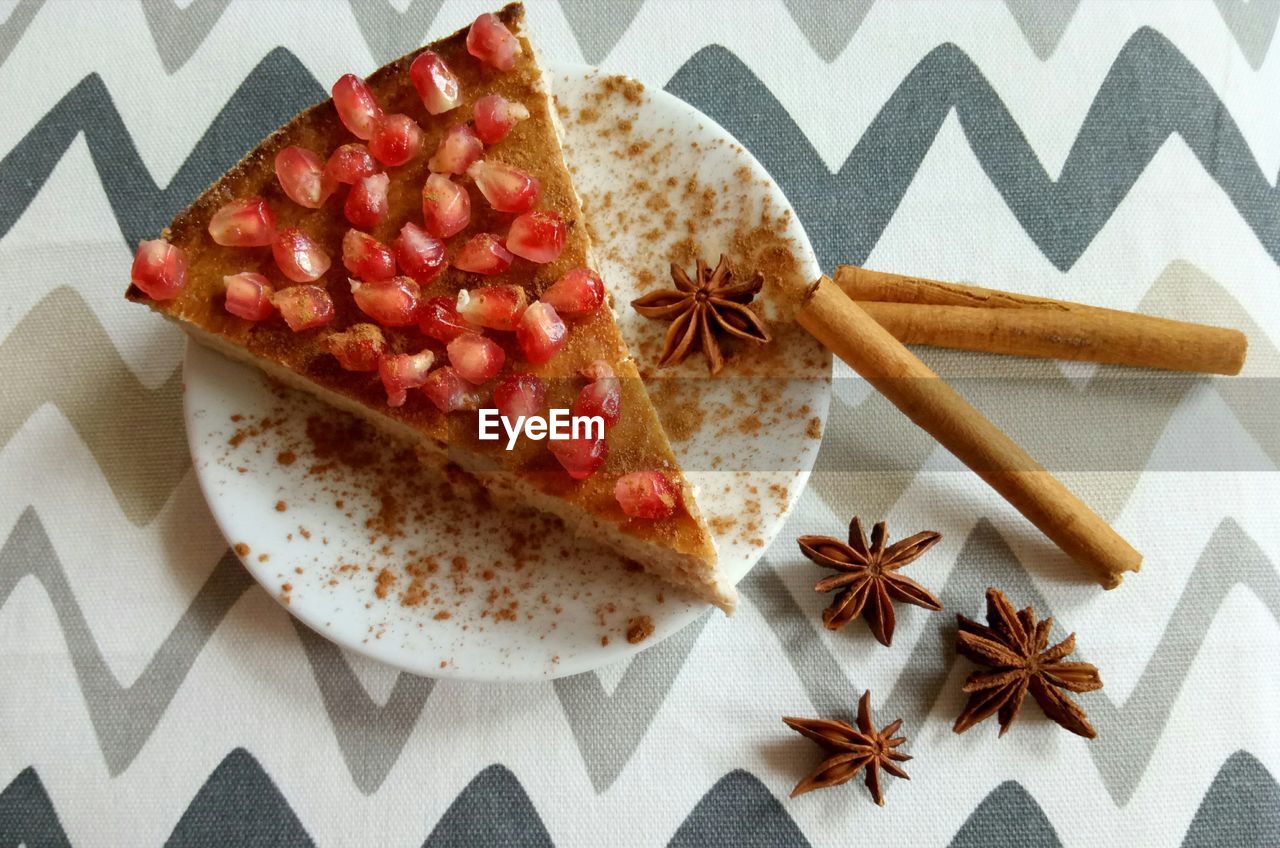 Close-up of pomegranate seeds on dessert in plate on table