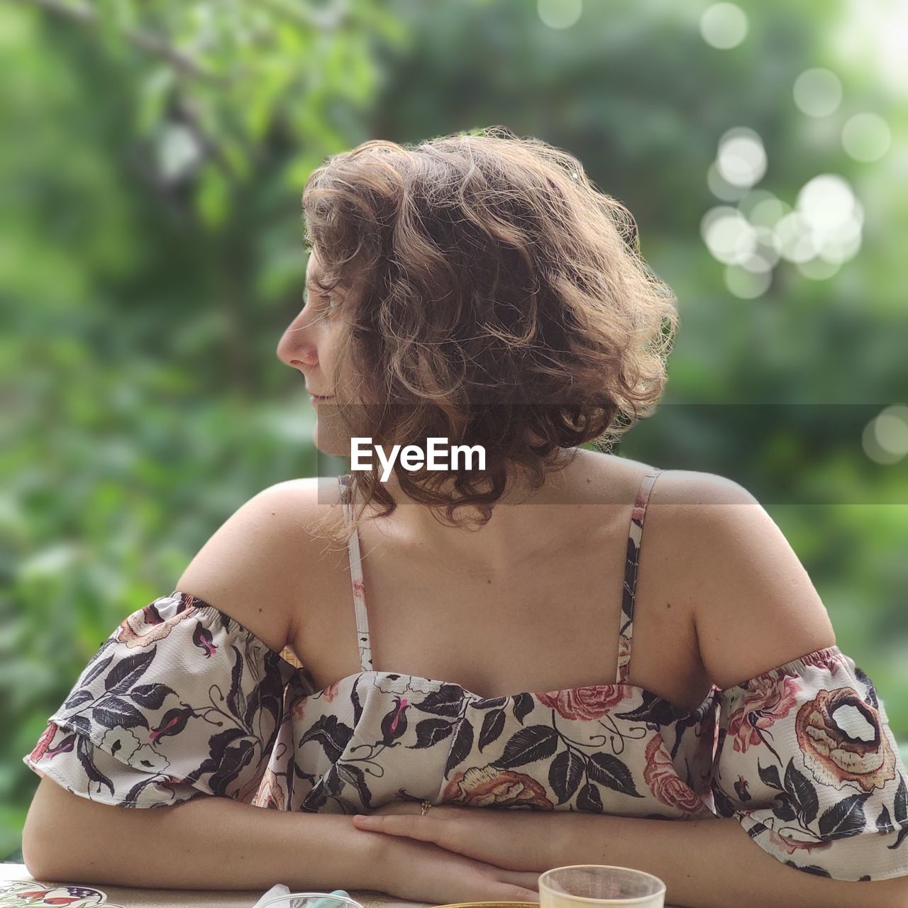 Rear view of woman sitting outdoors