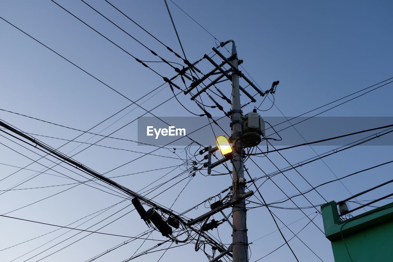 Low angle view of electricity pylon against sky