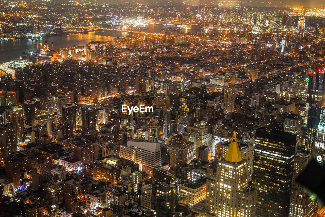 HIGH ANGLE VIEW OF ILLUMINATED CITY BUILDINGS