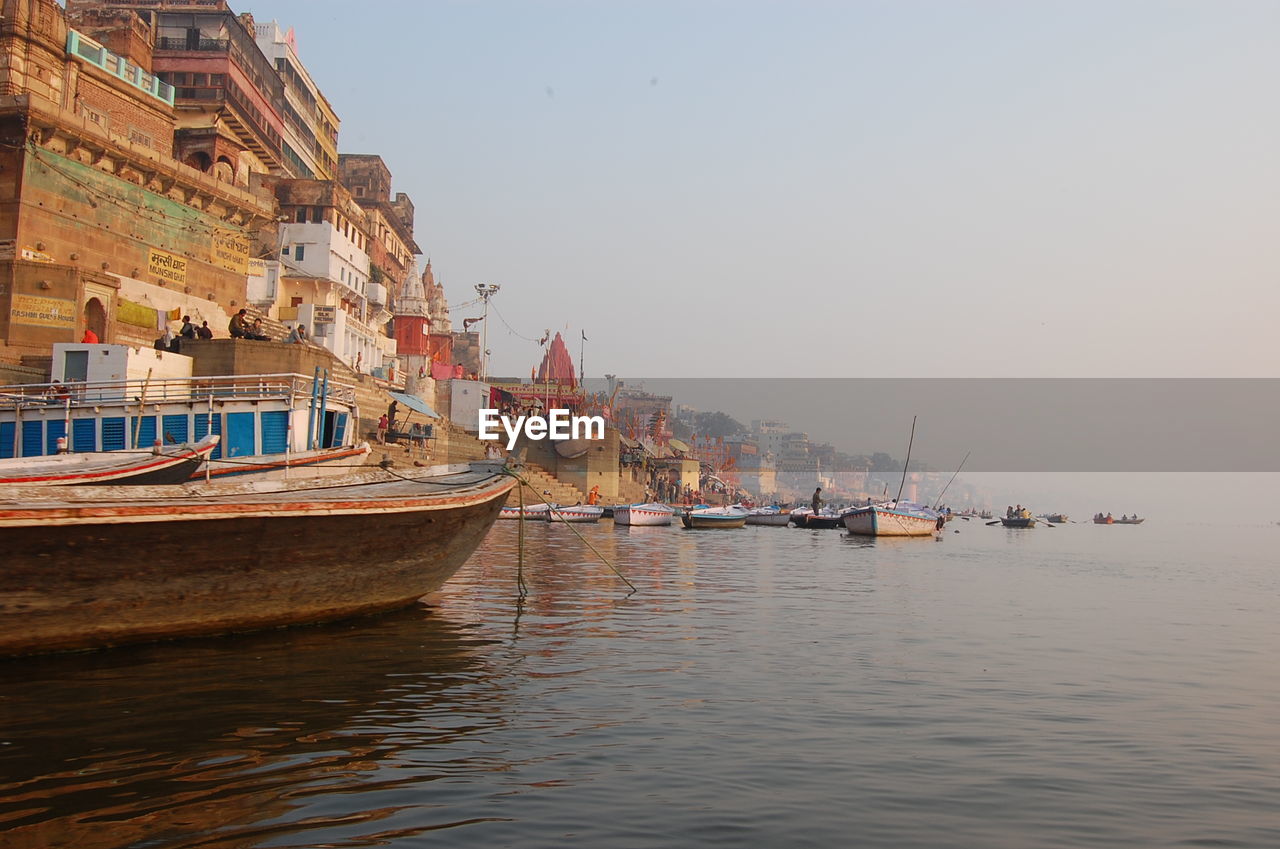 Boats in sea against clear sky