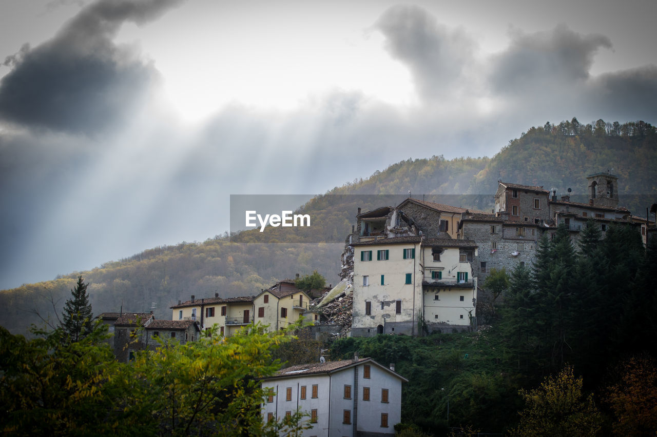 Buildings against cloudy sky