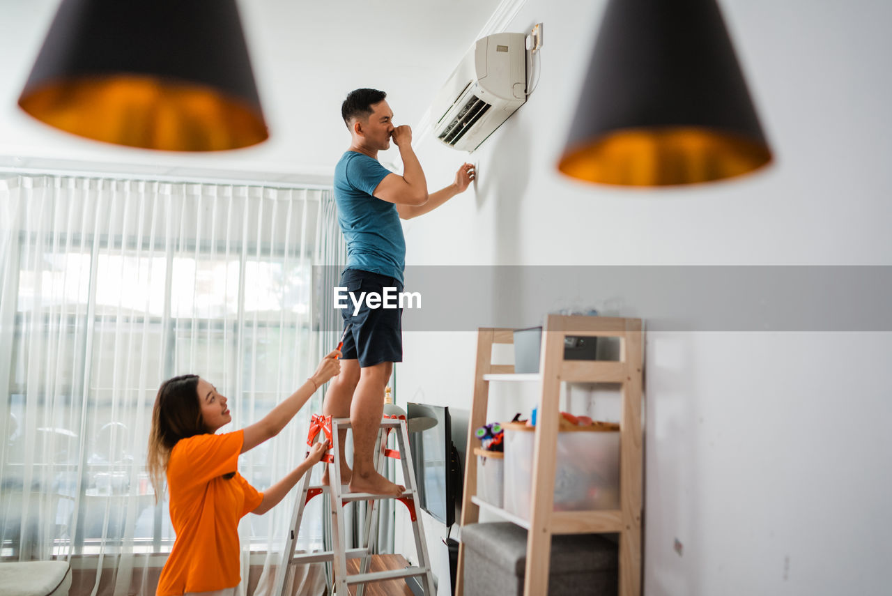 low section of woman holding illuminated light bulb