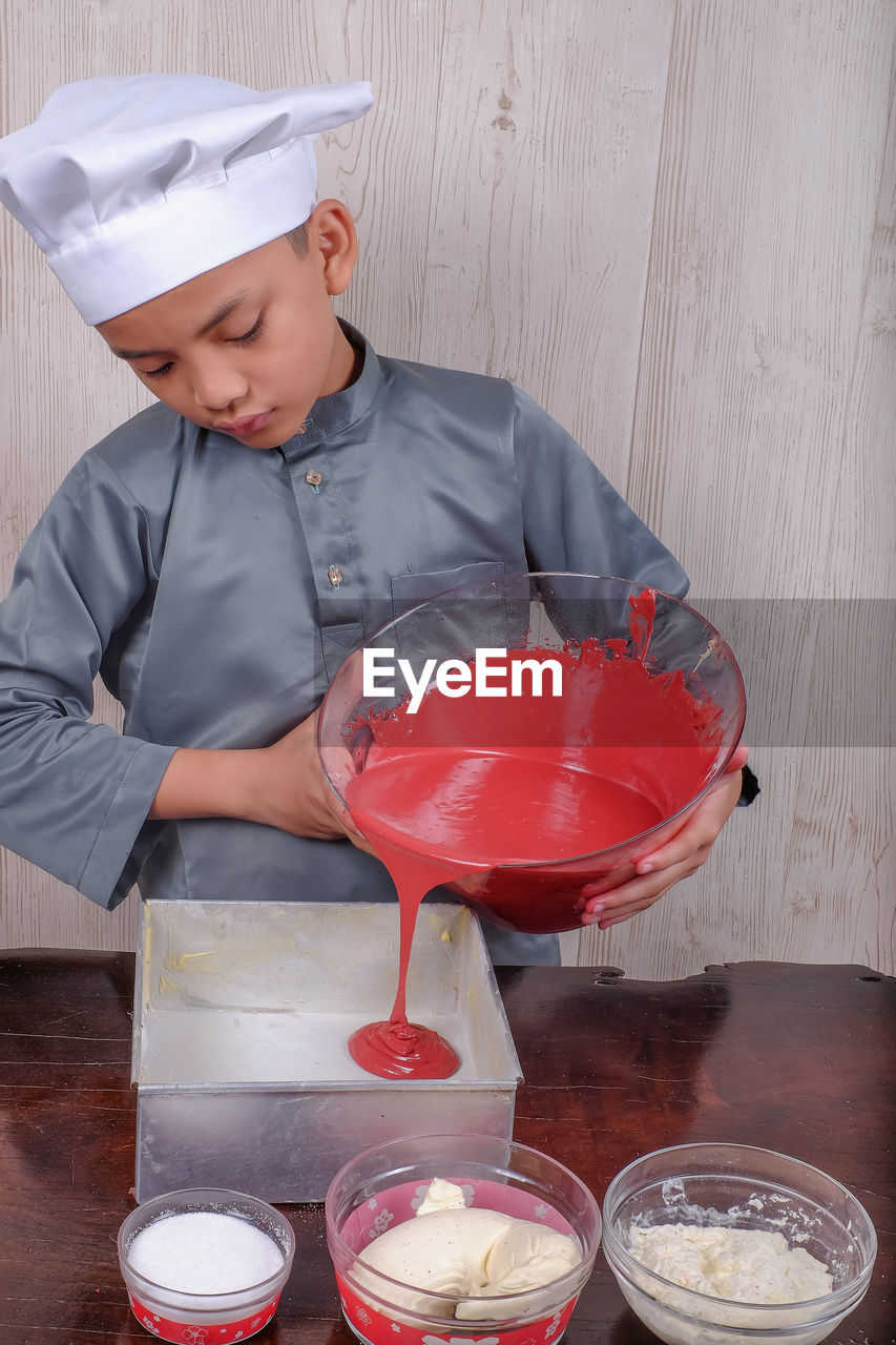 Boy preparing food on table at home