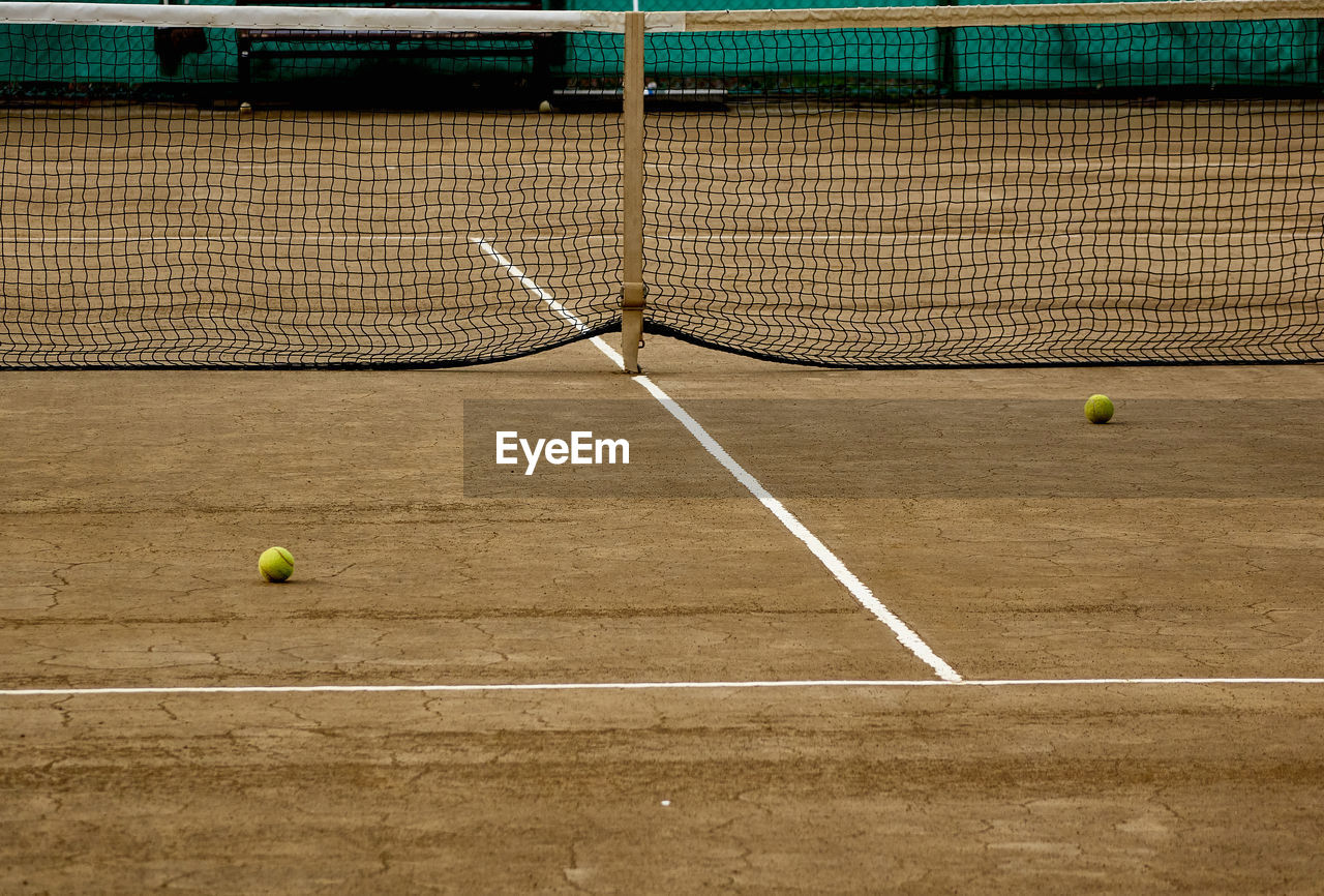 Tennis balls on ground in court