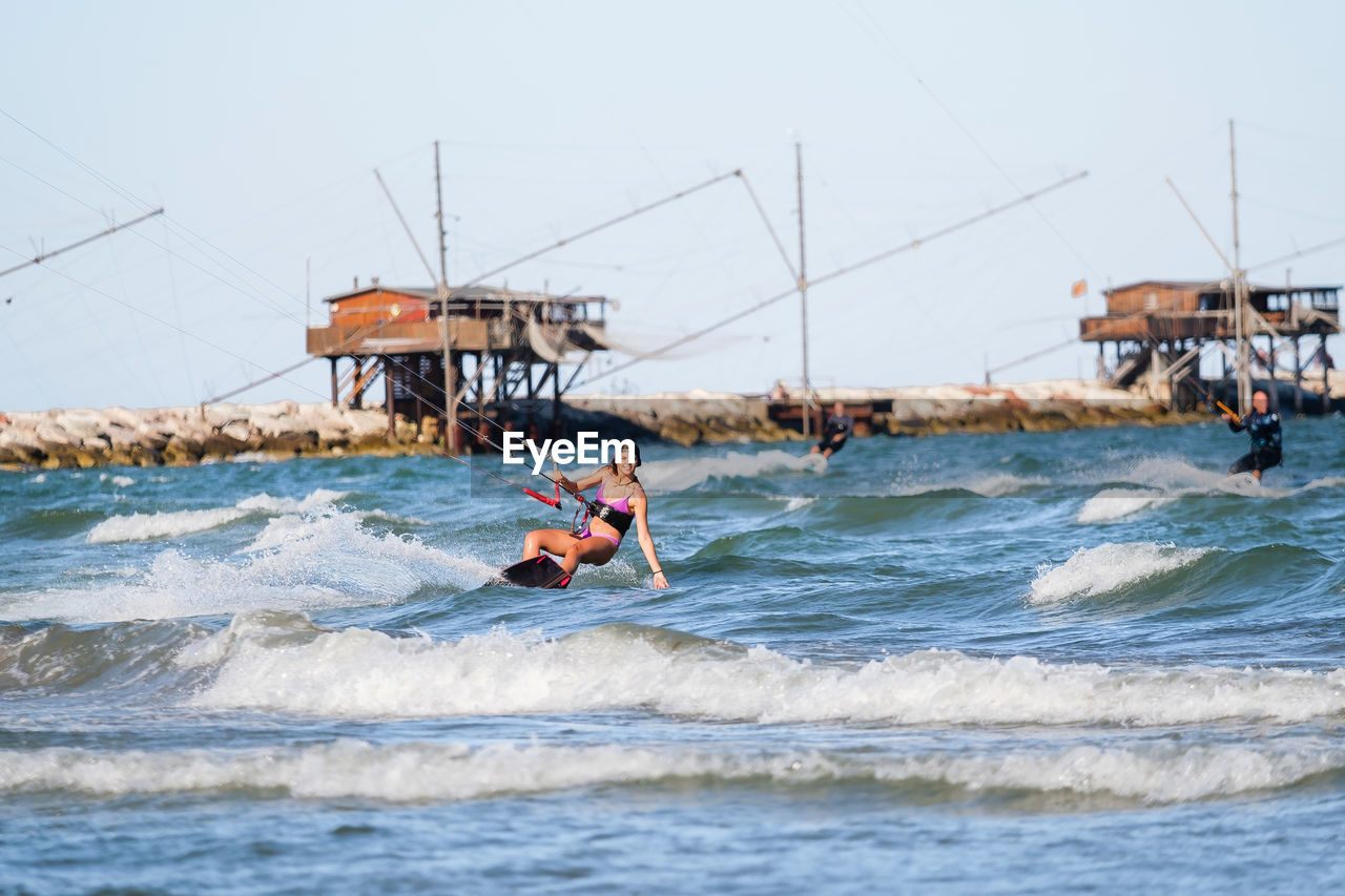 man kayaking on sea