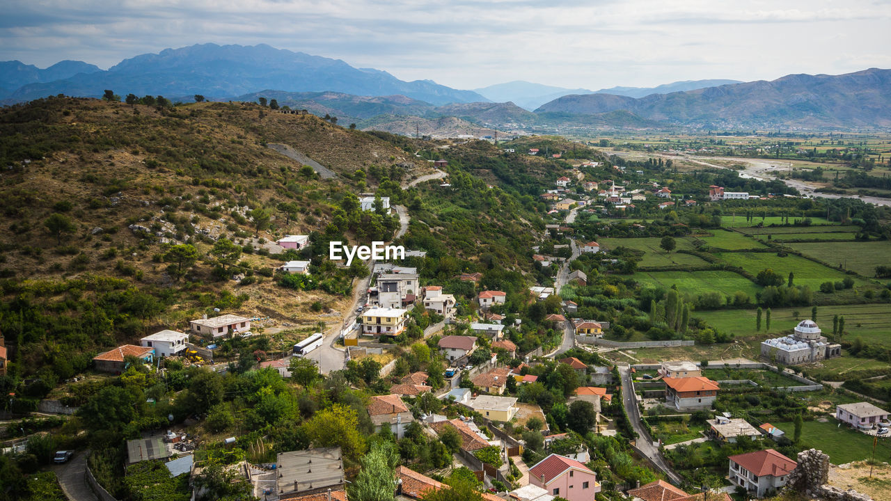 Town and landscape against sky