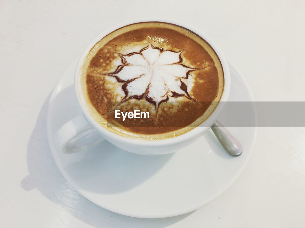 HIGH ANGLE VIEW OF CAPPUCCINO ON COFFEE