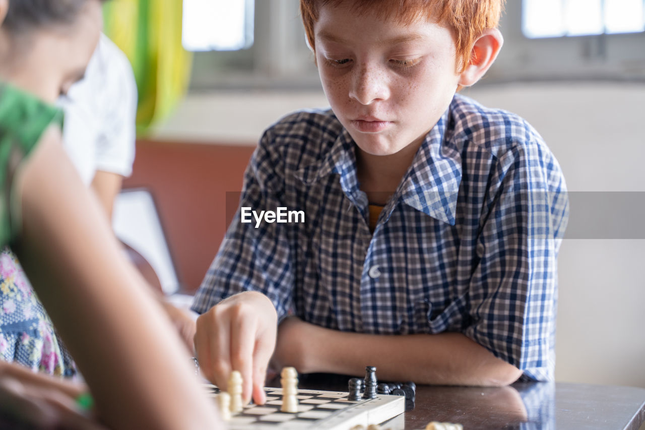 Portrait of boy playing on table