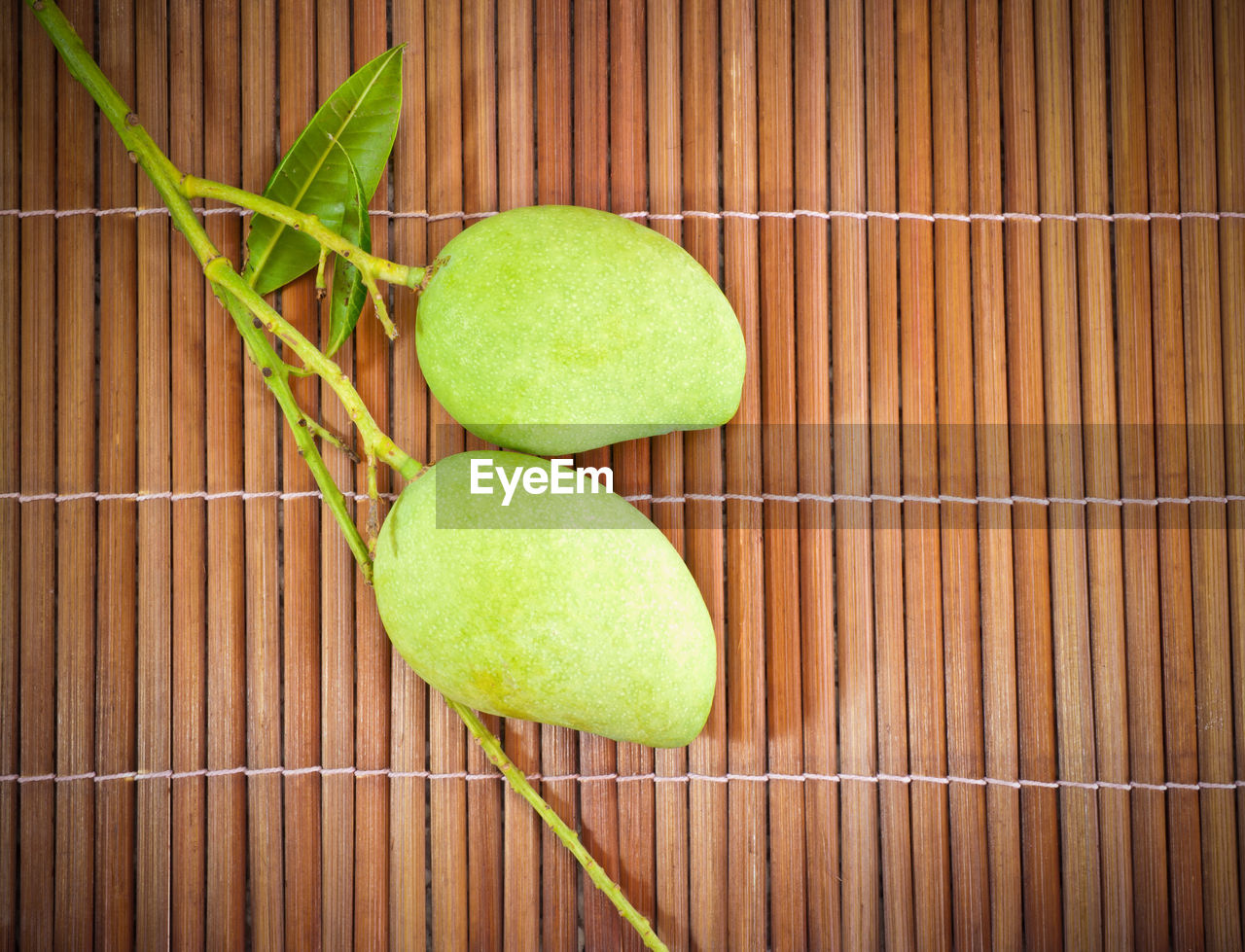 High angle view of raw mangoes on placemat