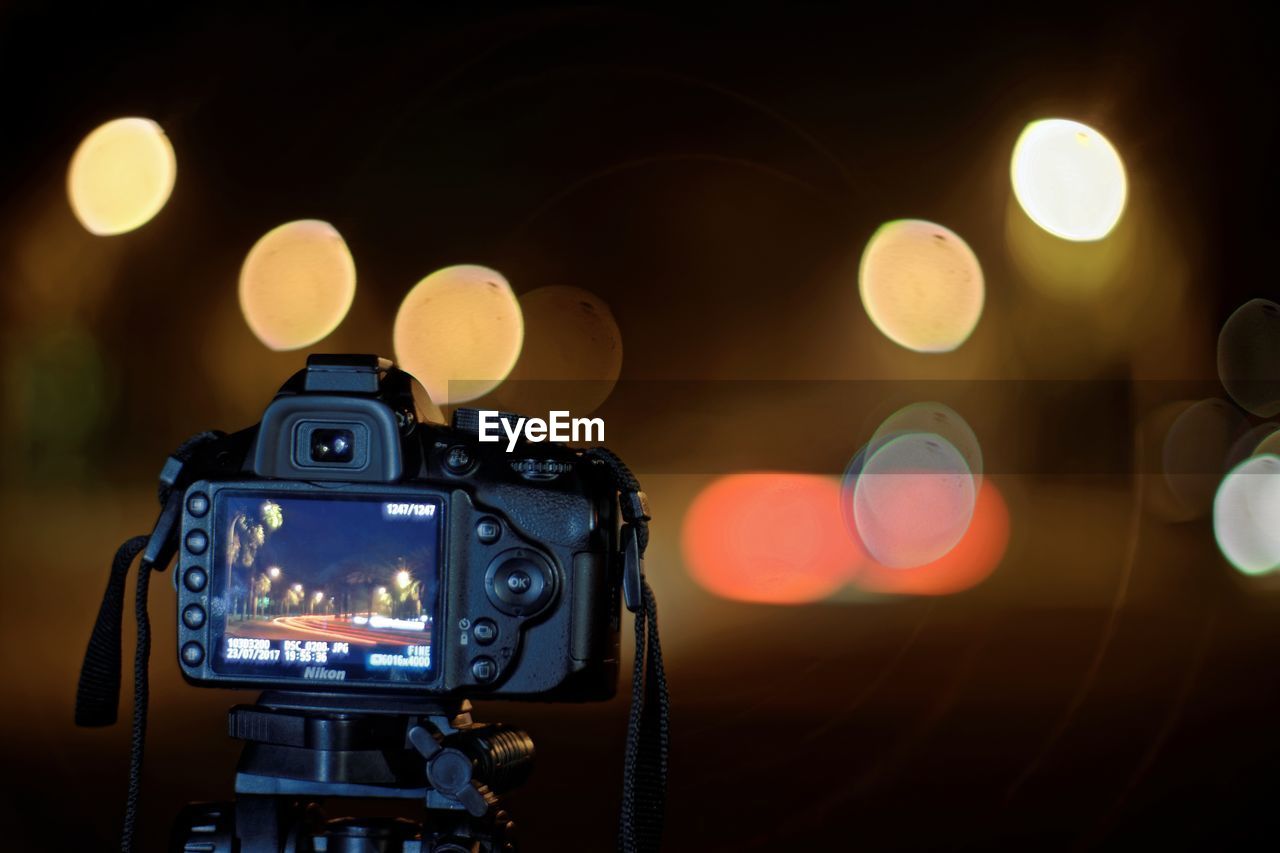 CLOSE-UP OF ILLUMINATED CAMERA