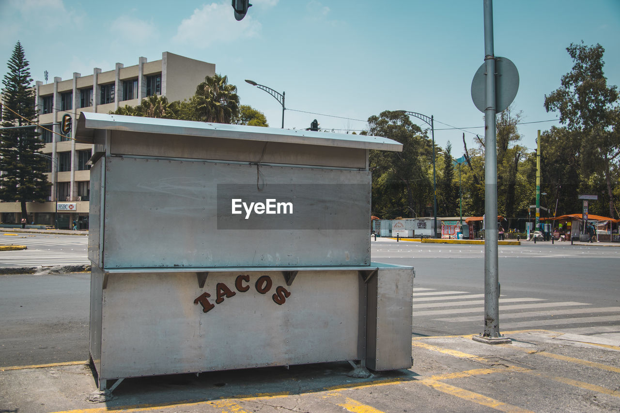 Taco stand on street against sky in city