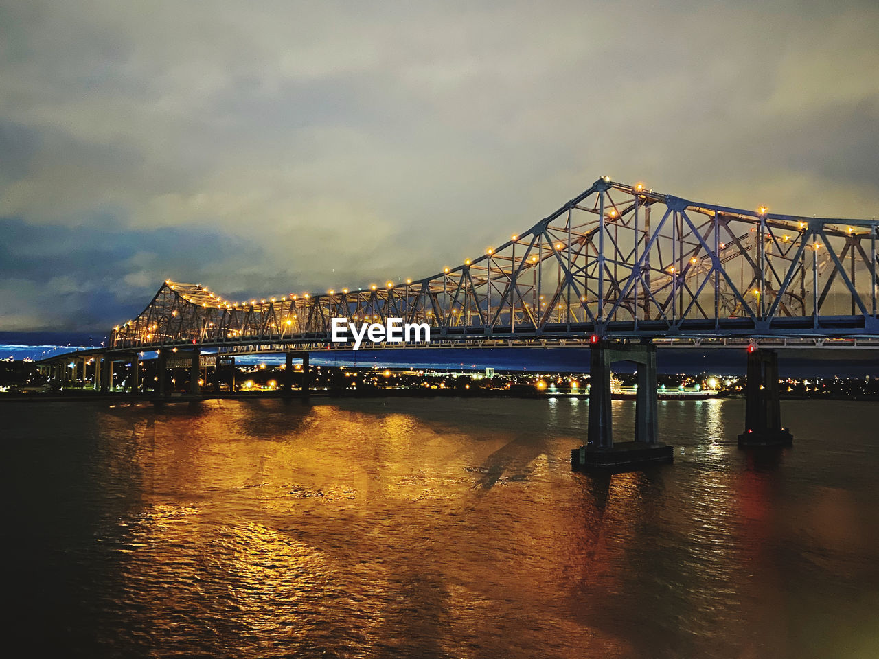 View of bridge over river against cloudy sky