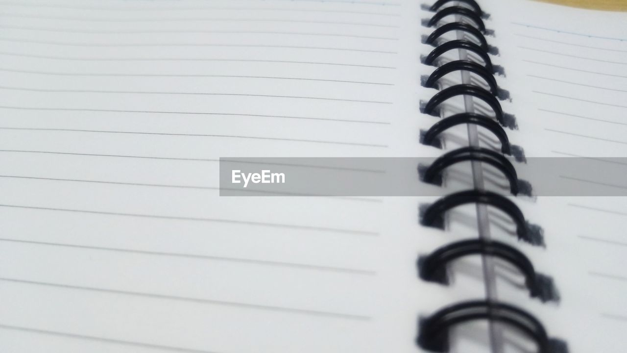 Close-up of open spiral notebook