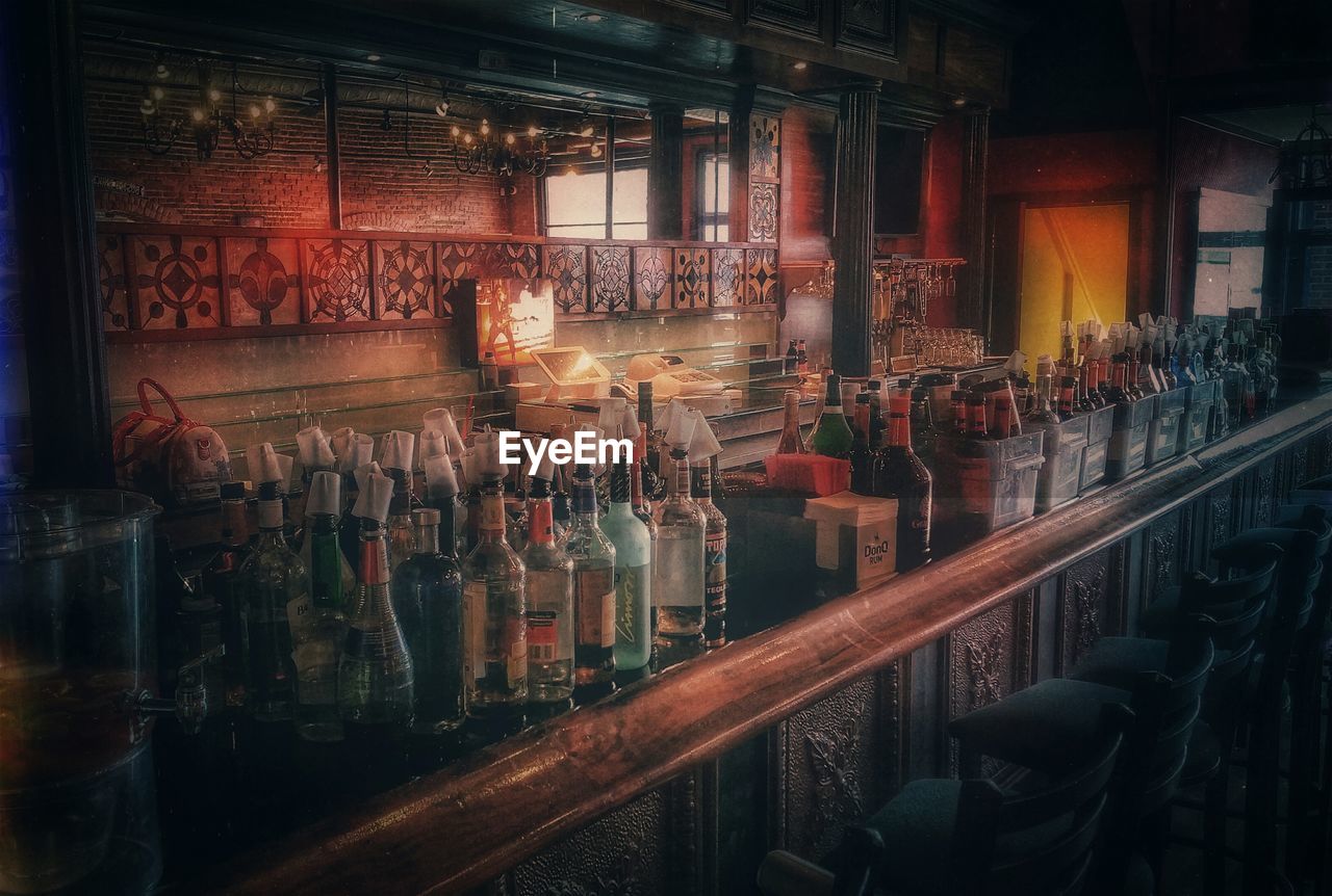 Various empty bottles on counter at restaurant