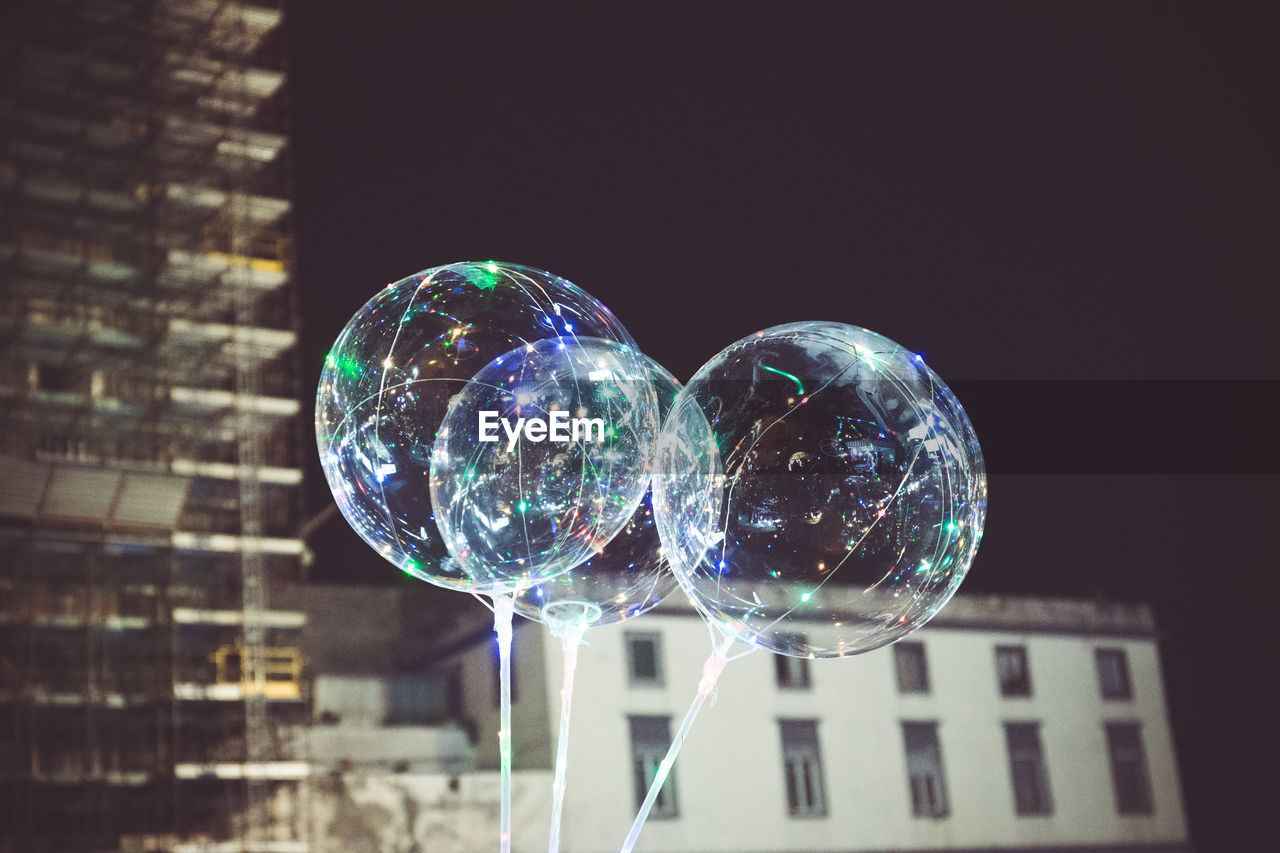 Low angle view of bubbles in mid-air