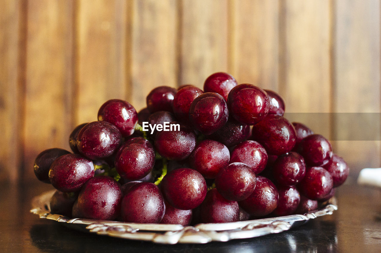 Close-up of cherries in plate on table